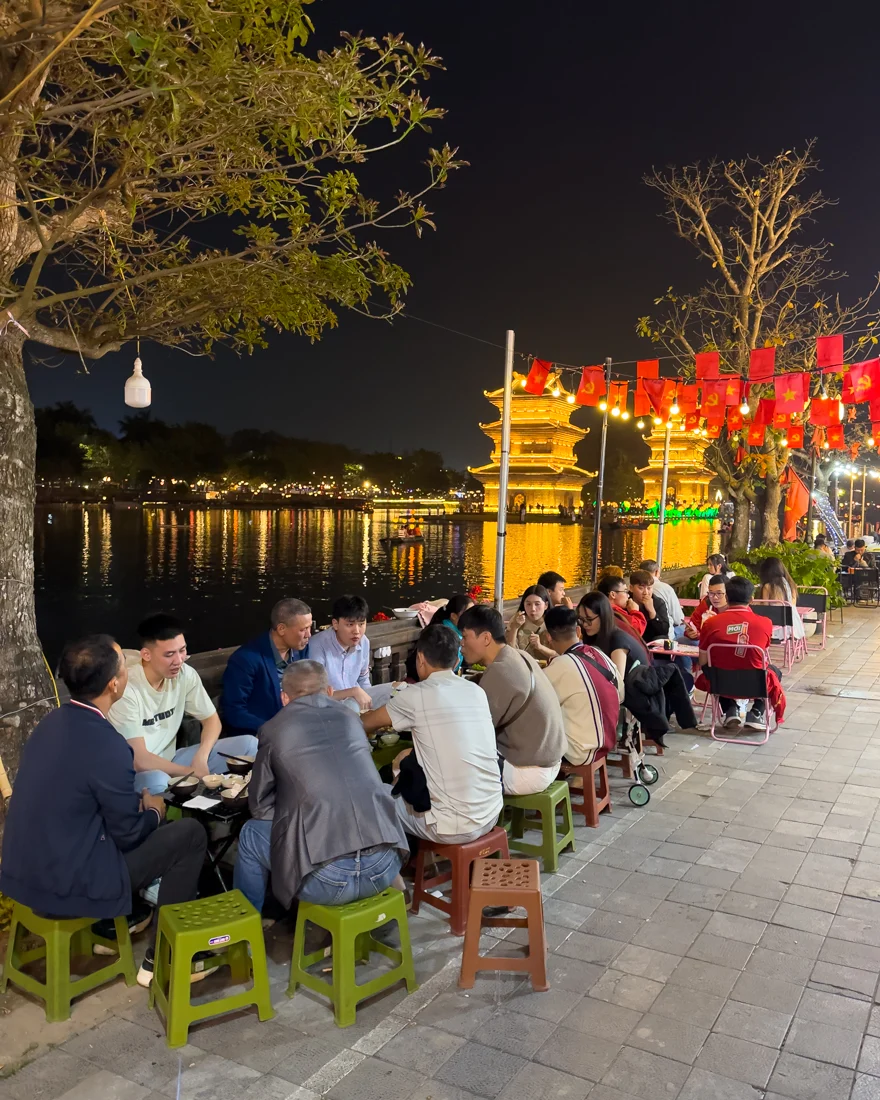 People eating along the river in Hoa Lu Old Town in Ninh Binh, Vietnam.