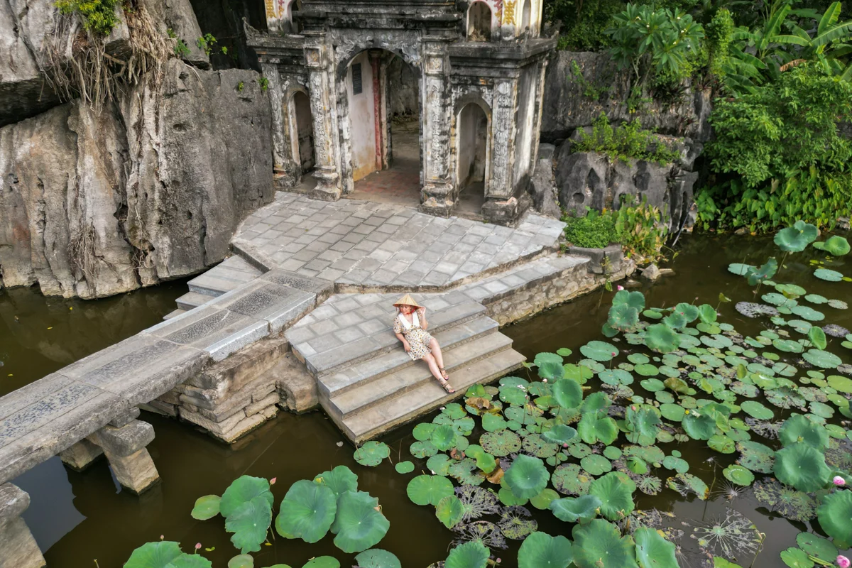 Woman at entrance of Bich Dong Pagoda in Ninh Binh, Vietnam.
